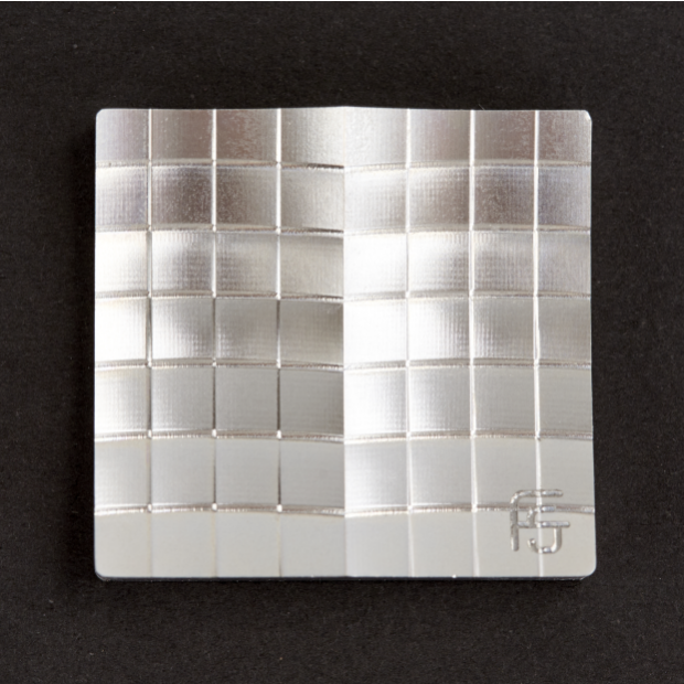 A precision CNC machined aluminum headlight section, showcasing multiple surface finishes like brush