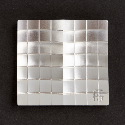 A precision CNC machined aluminum headlight section, showcasing multiple surface finishes like brush